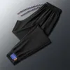 Nouveau pantalon de soie de glace d'été pour hommes, leggings décontractés à la mode et à la mode, pantalon décontracté pour les jeunes élastiques pour hommes élastiques