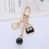 Keychains Lanyards Luxury Handbag Pendant Keychains Fashion Pearl Number 5 Tassel Keyring For Women Bag Ornament Car Key Chains smycken Tillbehör D240417