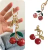 Anelli chiave designer COA Pink Crystal Cherry Keychain Borse di portafoglio di lusso DECARAZIONE Accessorio Accessorio Golden Catena Foglie verdi