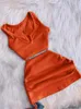 Tweede stuk jurk Streetwear Knit Sets Sets Crop Tops Mini Rok bijpassende oranje trekkoord Zwarte pakken