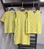 Tricot de tricots pour femmes Designer 2024 printemps / été nouveau jaune rond coule de coule de nouflé débarquant