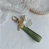 Diseñador llavero de llave de llave de llavero encanto carpeta de coche hembra anillo perla encanto de perla cinta verde conchas delicadas con llavero parto regalo bien bueno