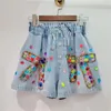 Frauen Shorts 2024 Sommer Europäische Waren Schwerindustrie Bogen eingelegene Farbe Diamant Perlen hohe Taille schlampig Weitbein-Denim-Frauen