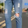 Jeans en détresse du nouvel élève du printemps pour la version coréenne masculine pantalon raccourci à la mode slim avec un pantalon rouge Internet élastique