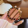 Accessorio geomanzia Nuovo stile nazionale cinese Super Fairy Maillard Tiger Eye Handsing Hands Cina-Chic Koi Elastico Elastico Regolabile Bracciale femmina