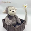 Wholesale Stuff Monkey Peluche Stuffed Soft Fluffy Plush Animal Sitting Custom Toy with Bow