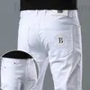 メンズジーンズデザイナーヨーロッパのピュアホワイト刺繍ジーンズ、メンズトレンディなカジュアルなスリムフィットレギンス、弾力性のある韓国版パンツF2SI