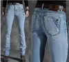 Jeans para mujeres Pantalones acampanados de alta calidad de botón de pierna recta para hombres de alta calidad