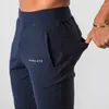 Мужские брюки запускают фитнес -тонкие спортивные штаны мужские повседневные тренировки.