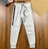 Space Cotton Tech Sports Pants Men Spring and Autumn Nuova pressione in gomma lunghe pantaloni della cerniera con cerniera casual