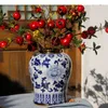 Lagringsflaskor guldpläterad allmän burk med lock blå och vita porslin burkar kosmetiska behållare konstgjord blommor dekorativ vas