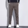 Мужские штаны Курбо Корейская версия весна высококачественная грузовая мода прямая офисная комбинезон эластичности бизнес -брюки.