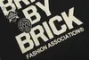 Męski projektant z krótkim rękawem Trend modowy Trendy litera z cegły nadrukowane rękawowe T-shirt z hip-hopowym pamiątkowym obrazem okrągłe szyję pół koszuli