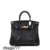 Fashion 2024 Platinum Alligator Borse Bone Bone Bone Simple Cowfide Womens Portable Hand Malina in pelle vera e propria