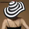 Chapéus de balde largos Chapéus de balde vendendo moda de moda hepburn estilo preto e branco listrado arco de verão chapéu de sol lindo str praia chapéu grande chapéu cônico j240425
