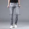 Jeans de créateurs pour hommes jeans européens jeans élastique élastique slim slim small pieds droits mode pantalon gris pour hommes lavés à la mode