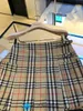 الأصلي 1TO1 Buurberlyes Designer Compley Classic Plaid Fashion Skirt High Weist Aline Skirt فستان منقوش عالي الجودة مع شعار أصلي