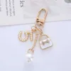 سلاسل المفاتيح Lanyards Luxury Handbag Pendant Ceychains Fashion Pearl Number 5 Tassel Keyyring for Women Bag Ornament Car Kains Exclseories Jewelry Association