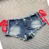 Kvinnors shorts 2023 Kvinnor Sexig delad denim Shorts Sidobandage Ultra-Low Rise Jeans Shorts Nightclub Pole Dancing Hot Pants Y240425