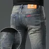 Ende hohe Jeans Herbst und Winter dicke angemessene Straße Stickerei Elastic Smoke Grey Modemarke Vielseitige Jugendhose für Männer