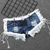 Kvinnors shorts 2022 Nya kvinnor med låg midja bundet bandage denim shorts nattklubb disco dj strand kort feminino y240425