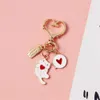 Keychains Lanyards Cute Love Heart Kitten Keychain Cartoon Black White Cat Key Ring for Girls Bag Car Ornaments Earphone Case Pendant Couple Gifts