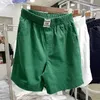 Heren shorts 2024 Nieuwe zomer dunne dames vaste kleur elastische hoge taille epaulet pocket pocket mode brede poot broek los rechte casual Q240427