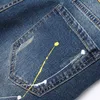 Mäns jeans 2024 Nya retro tårar jeans män tvättar blå elastisk ultratunna denim byxor patch mode färg prickar hip hop mens trusersl244