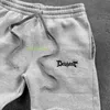 Pantalones de hombres pantalones casuales negros para hombres y mujeres con letras de moda impresas en algodón Y2K 100 pares de pantalones deportivos estilo callejón suelto y cómodo pantalones de pantalones l2404