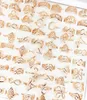 whole 100pcsLot Gold Plated Women Fashion Rings Laser Cut Flowers Metal Alloy Ring Party Gifts Mix Styles Brand New5670812