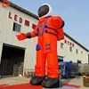 Buitenactiviteiten 8mh 26ft High Orange opblaasbaar astronaut Model opblaasbare Spaceman Cartoon Air Ballon met ventilator te koop