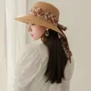 Cappelli larghi brime protezione UV donne cappello da sole moda di colore solido pescatore traspirante con nastri ragazza estiva paglia
