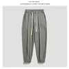Koreańskie ubrania ubrania letnie cienkie spodnie luźne wiązki stóp dresowe mens Ice jedwabny kolor solidny kolor casual spodni Homme 240418