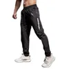 Pantaloni da jogging elastici uomini che corrono più dimensioni con cimpelli sportivi con cerniera fitness da palestra jogger di bodybuilding pantaloni sportivi 240412 240412