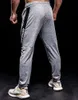 Pantaloni da jogging elastici uomini che corrono più dimensioni con cimpelli sportivi con cerniera fitness da palestra jogger di bodybuilding pantaloni sportivi 240412 240412