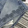Modedesigner kvinnors jeans vår och sommar ny färsk akademi stil tung industri blommor ihålig ren bomull hög midja a-line denim kort kjol