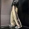 Pora de rayas laterales Piernas ancha de la pierna coreana Pantalones de carga de hip-hop de cadena de carga