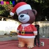 Cute gigantesco orsacchiotto gonfiabile marrone natalizio con cappello rosso per decorazioni pubblicitarie per le vacanze