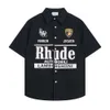 Rhude Shirt Designer Luxury Fashion Mens Shirts Casual Shirts Letter Emblem Mens and Womens Flip Neck Shirt Stand Courte Souche Été