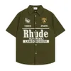 Rhude Shirt Designer Luxury Fashion Mens Shirts Casual Shirts Letter Emblem Mens and Womens Flip Neck Shirt Stand Courte Souche Été