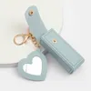 Nyckelringar 1 st bärbara läppstiftpåsar plånbok med spegel nyckelring mini förvaring väska för kvinnor gåva fast färg läppstift skyddande täcke