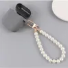 Porte-clés en alliage de perles pour femmes, 10 pièces, nouveau sac de voiture minimaliste, Bluetooth, couvre-chef, pendentif, bijoux, vente en gros, 240125