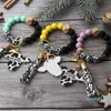 Keychains Lanyards 2024 Fashion Silicone Cursive Cow Bead Armband Wood Disk Armband Cow Tassel Ox Head Wrist Key Ring Charm Pendant Accessory