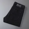 Męski projektant dżinsów Spring i Autumn Xintang Nowy czarny dla mężczyzn Slim Fit Małe stopy Elastyczna europejska marka mody Casual Long Pants EI52