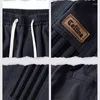 Calça masculina Moda coreana Loose Versátil Casual Men Stripe sólido Canda elástica Pockets Pockets de perna larga Larra esportiva reta