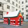 Tente gonflable de Noël en plein air 6x4x4m 20ftx10ftx10ft Maison rouge soufflée à l'air Cottage de village de Noël géant pour la décoration de Noël d'hiver