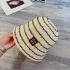 Womens striped bucket hat with hundred letter sticker design minimalist style outdoor breathable knitted designer beach hat