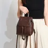 Sacs d'école Petit sac à dos à rabat avec cordon de serrage pour femmes Mini sac d'école texturé en cuir PU sac à bandoulière de voyage Vintage sacs à dos pour filles