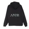 Zomer 2024 Amari Designer Heren Dames Hoodies Bedrukte Mode Heren T-shirts Katoen Casual Dames T-shirts Korte Mouw Luxe A Miris Hip Hop Streetwear Oversized