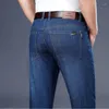 Jeans masculinos soltos em linha reta material de algodão negócios casual elástico calças jeans primavera/verão marca juventude de grandes dimensões